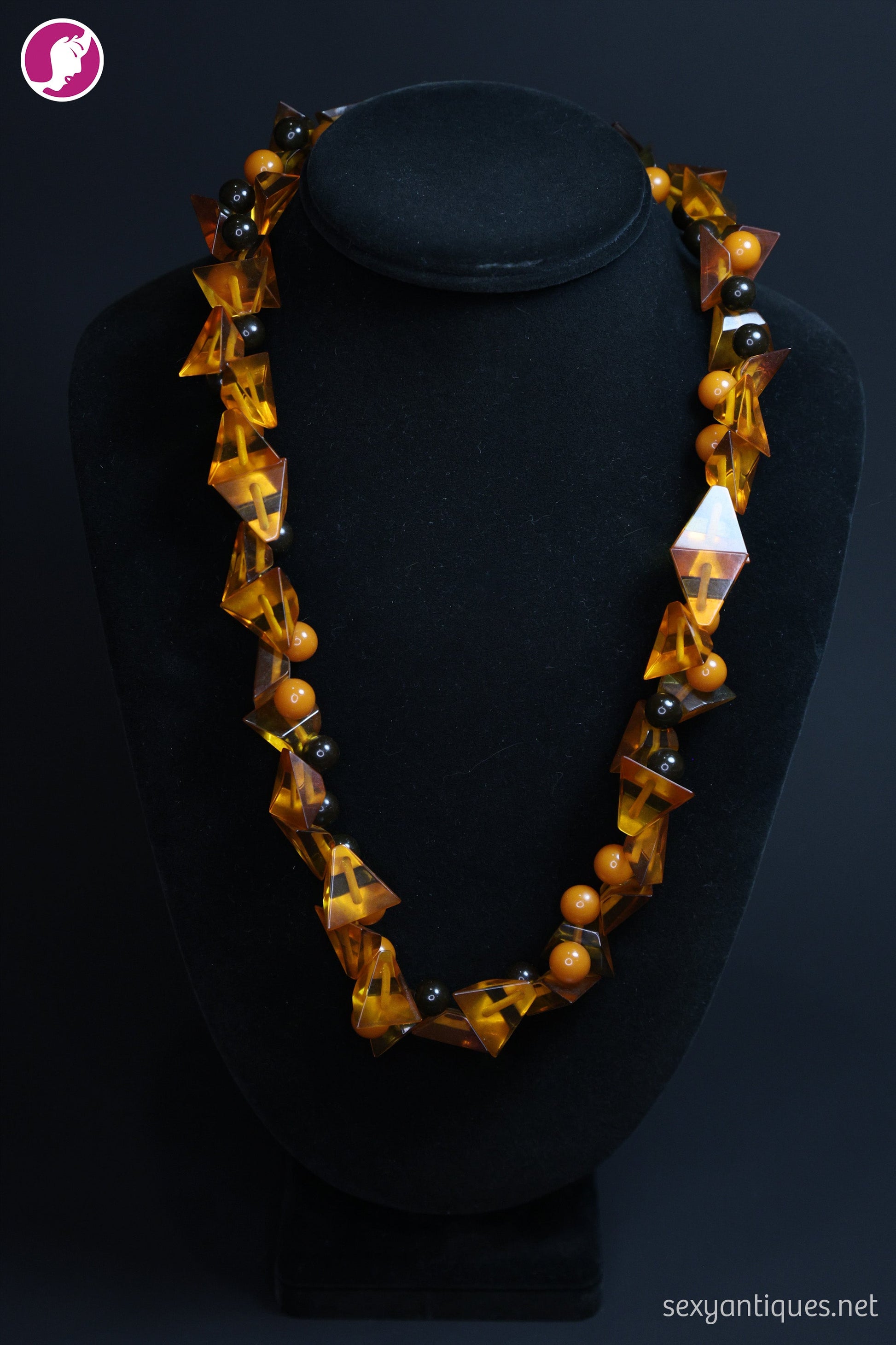 1930s Art Deco amber Bakelite necklace product shot, flat lay on neutral background