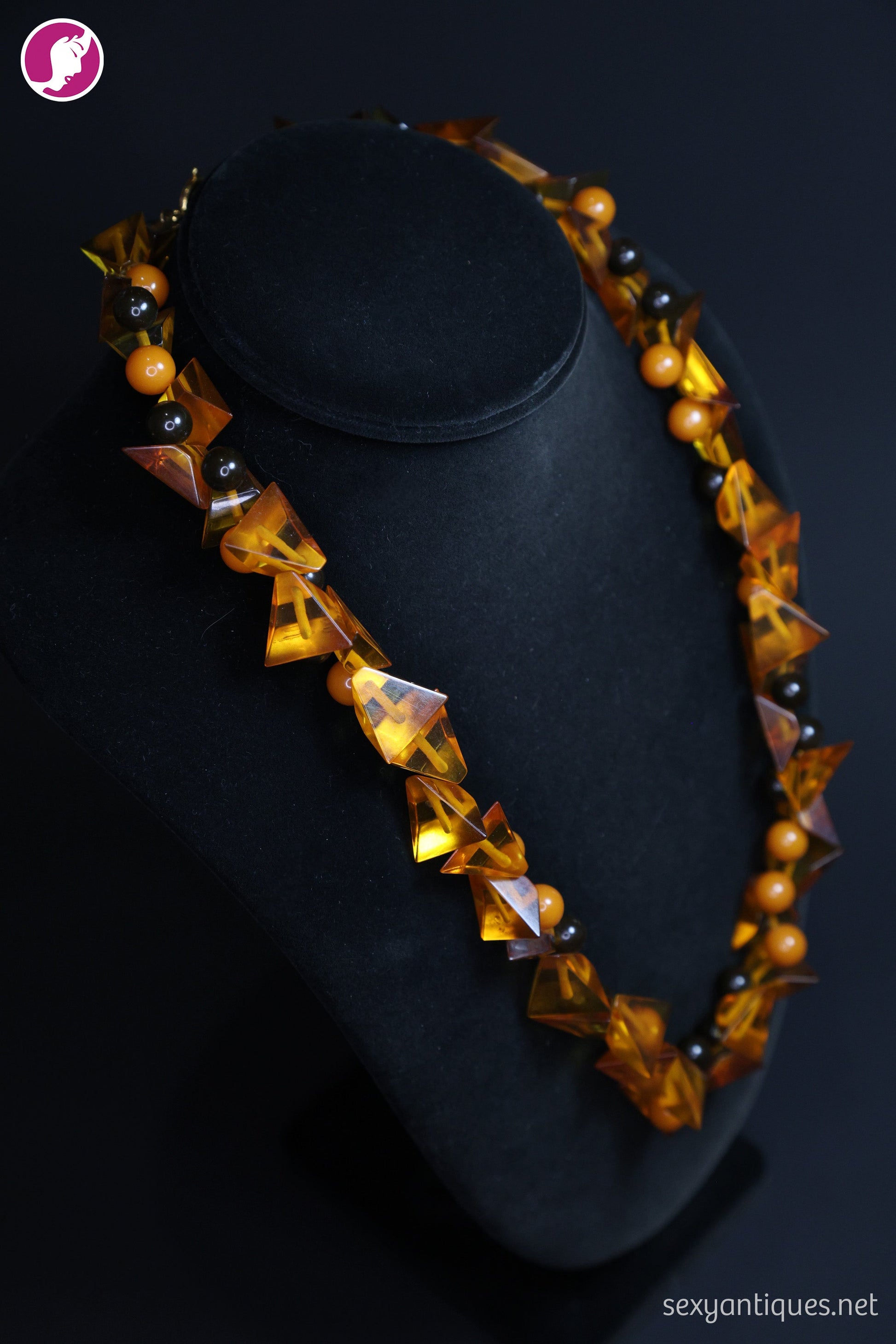 Close-up product photograph of genuine Art Deco amber and Bakelite antique necklace beads